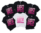 pile of black and white graphic tees reading i wear pink for