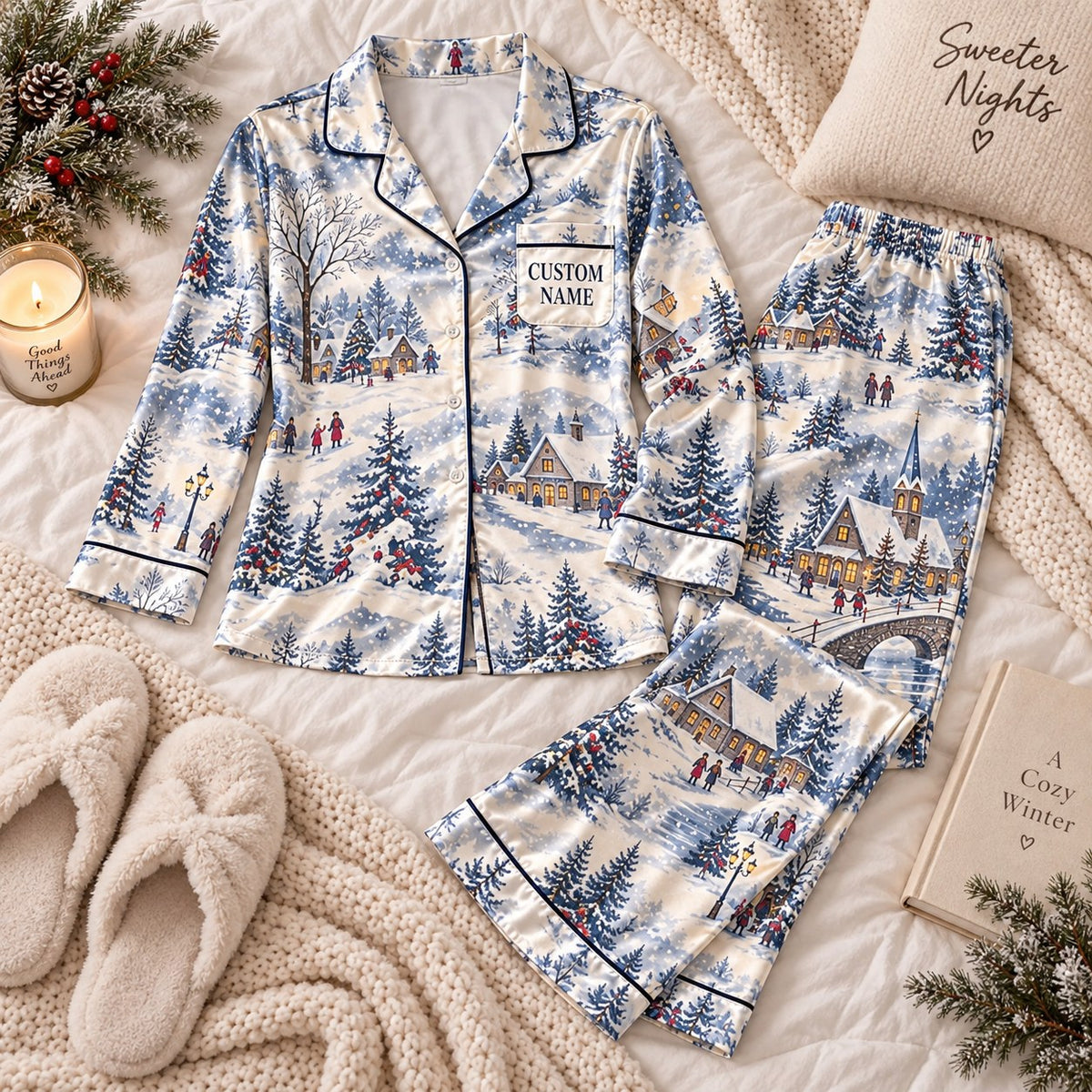 blue snowy village satin pajamas flat lay with a custom name on the chest