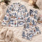 flat lay of snowy village satin pajamas with a custom name on the chest