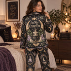 woman stretching in witchy woman halloween satin pajama set in bedroom