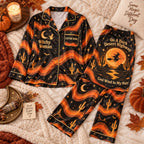 orange desert witch satin pajamas flat lay with a custom name on the chest