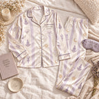 lilac striped yoga satin pajamas flat lay with a custom name on the chest