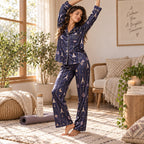 model on bed holding mug in matching starry satin pajama set