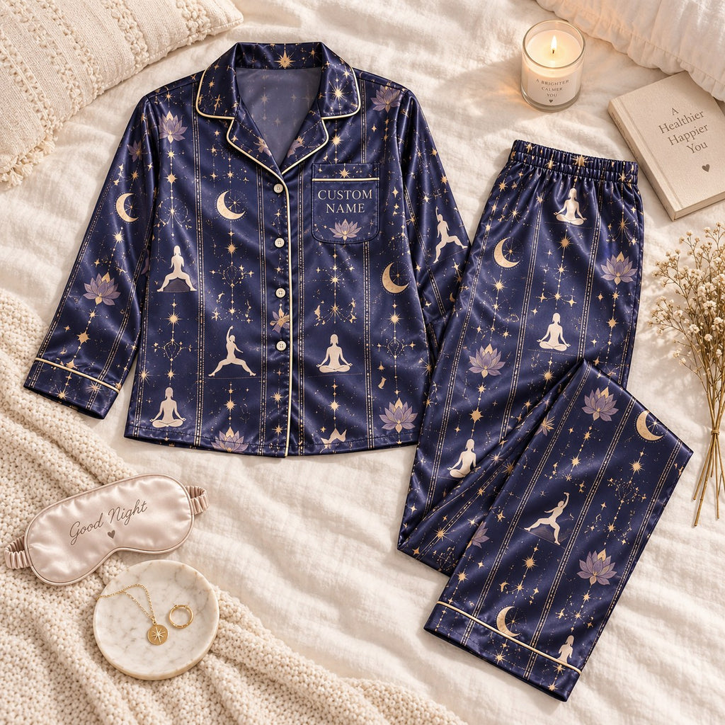 flat lay navy yoga pose satin pajamas with a custom name on the chest